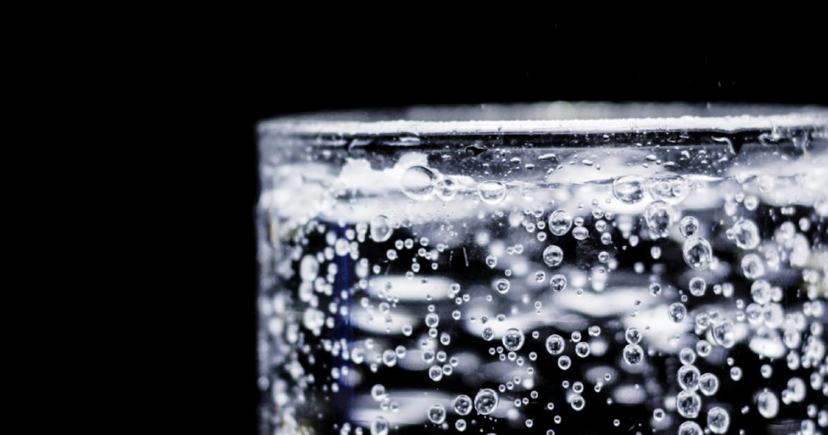 Crystal clear spa water with mineral bubbles in a serene spring setting